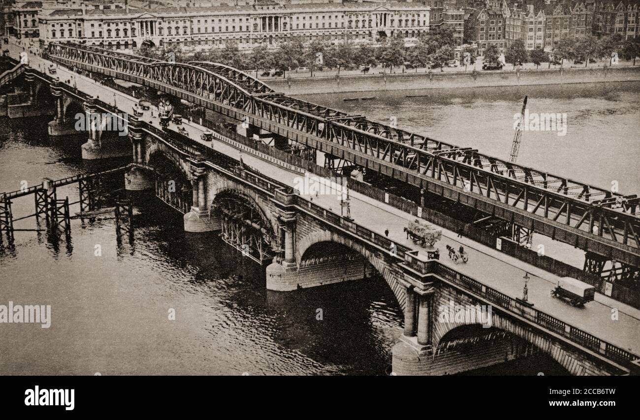 Waterloo Bridge crosses the River Thames between Blackfriars Bridge and Hungerford Bridge, in London. For safety reasons, London County Council decided to demolish the bridge and replace it with a new structure designed by Sir Giles Gilbert Scott in the 1930s. The project was placed on hold due to the Second World War, but a temporary steel bridge was installed. Stock Photo