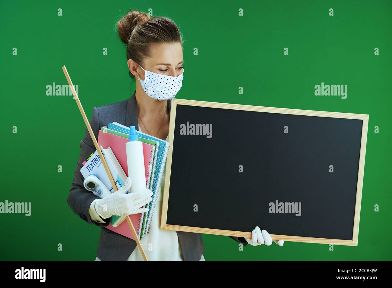 modern woman school teacher in white blouse with medical mask, rubber ...