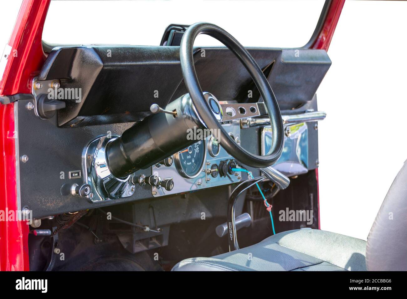 Fragment of the cockpit of a historic jeep with instruments and a steering wheel Stock Photo