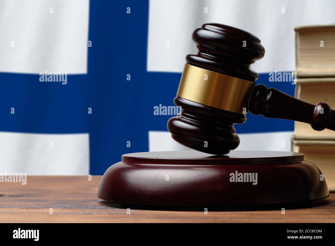 Justice and court concept in Republic of Finland. Judge hammer on a flag background. Stock Photo