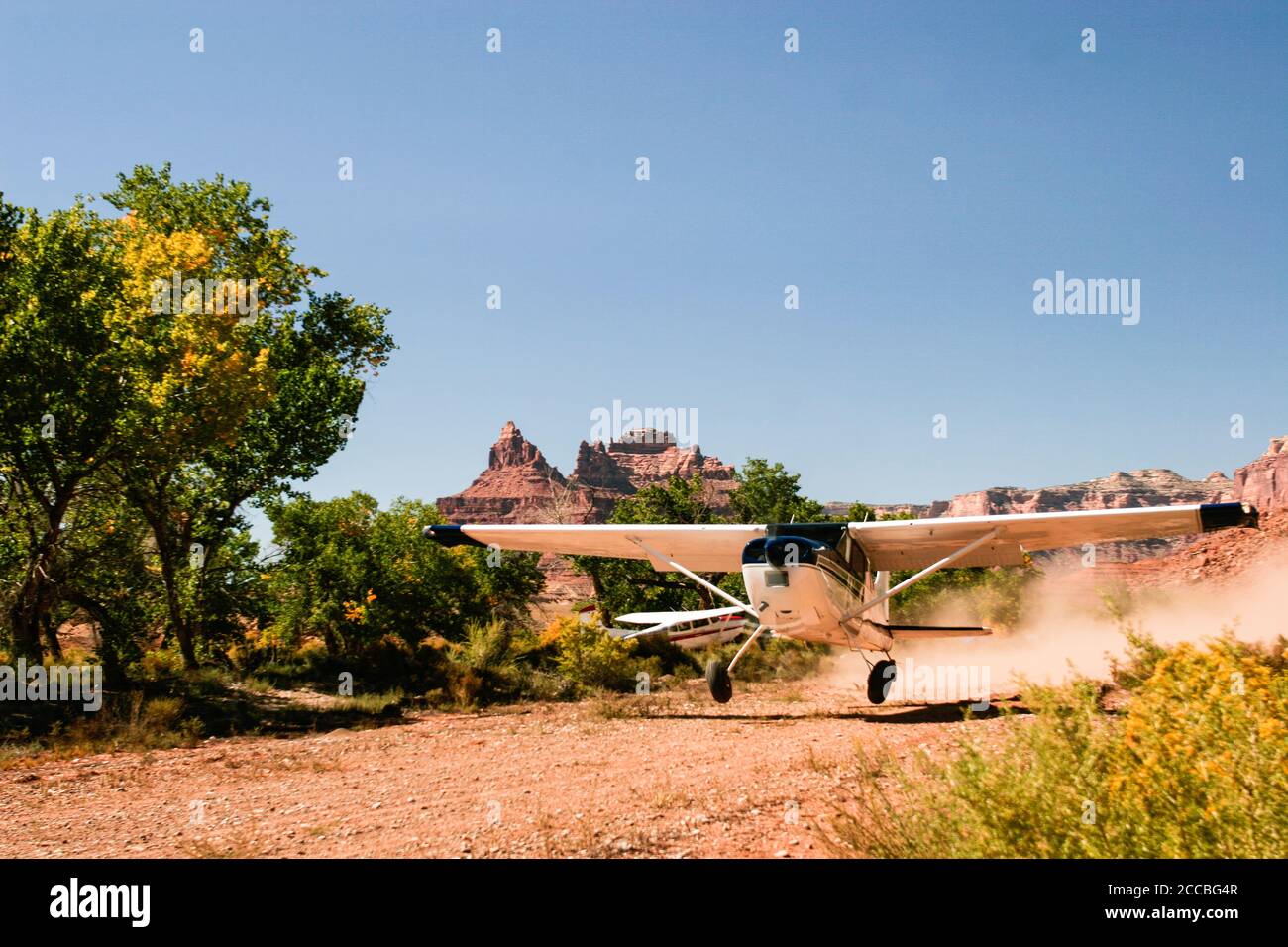 A Cessna 185 Skywagon of the Utah Backcountry Pilots Association takes off from the remote Mexican Mountain airstrip on the San Rafael Swell in Utah. Stock Photo