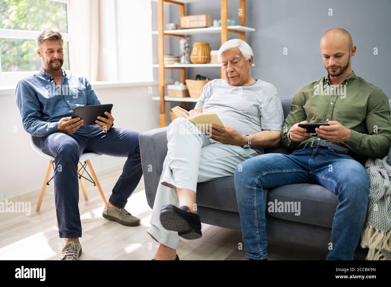 Three Generation Men Spending Time Together At Home Stock Photo