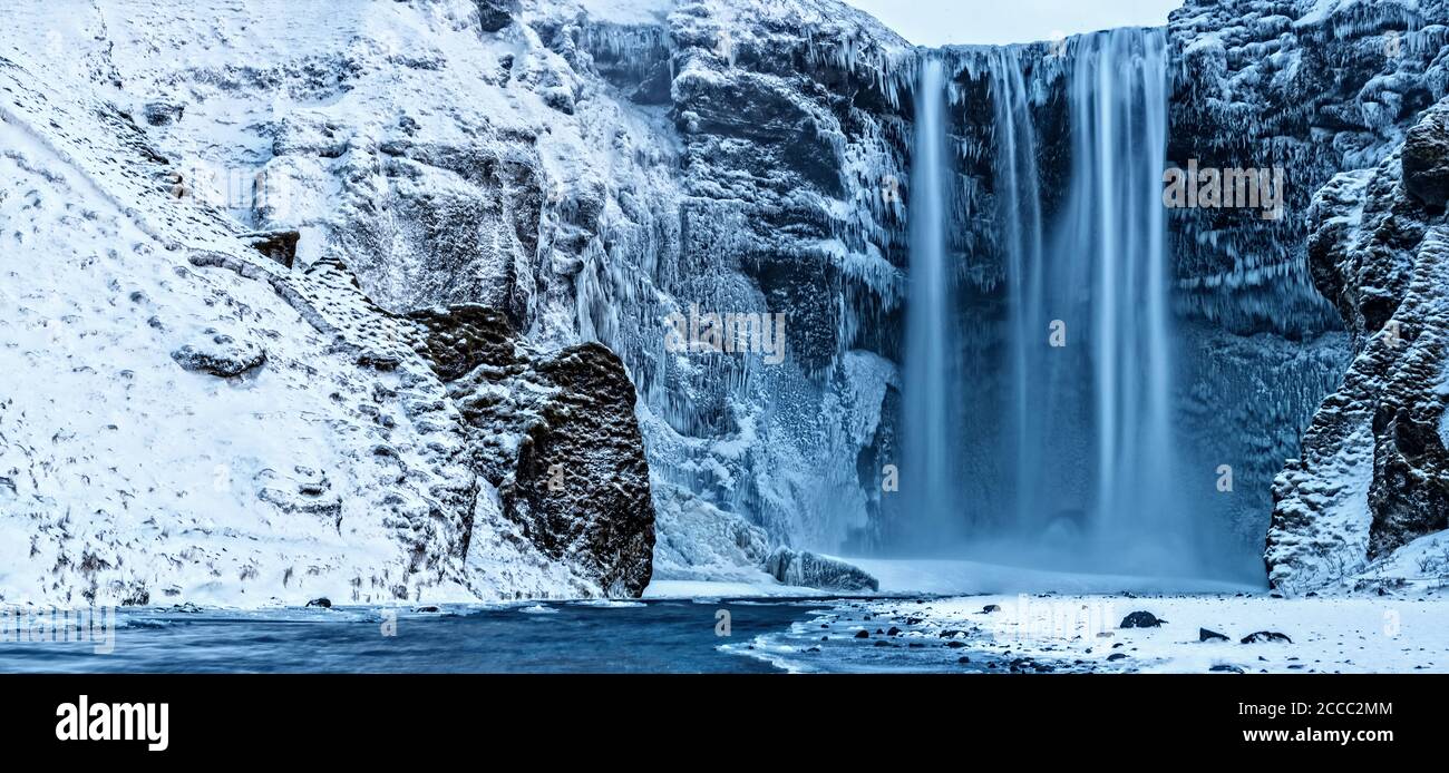 Beautiful panoramic photo of Skogafoss waterfall in winter, Iceland. Long exposure Stock Photo