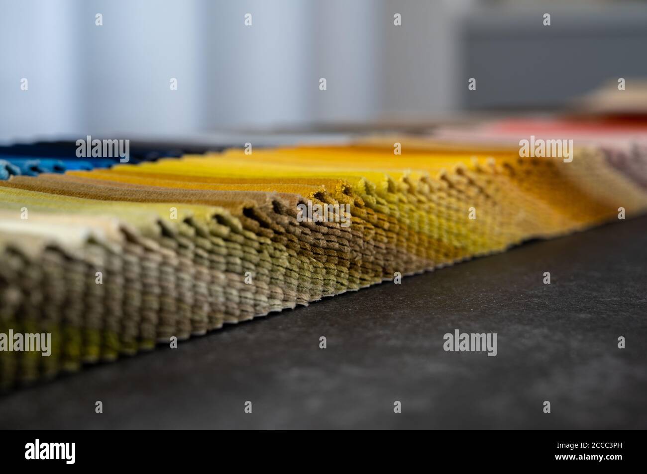 Folded gradient colored samples of luxury velvet placed on a table Stock Photo