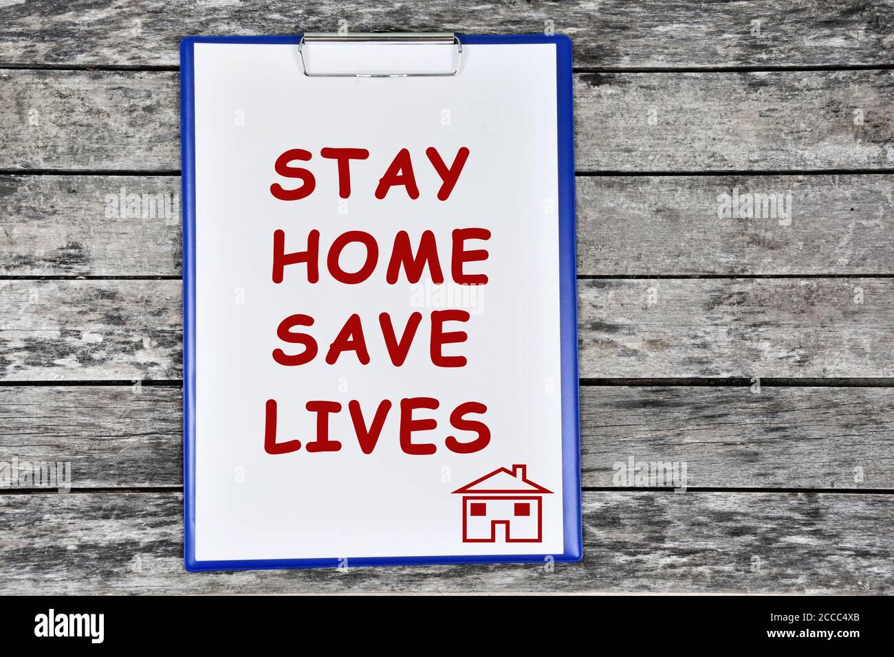 Text Stay home save lives on white paper clipboard Stock Photo
