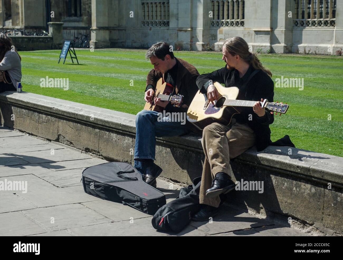 Two street musicians playing guitars in the city centre, Cambridge, UK Stock Photo
