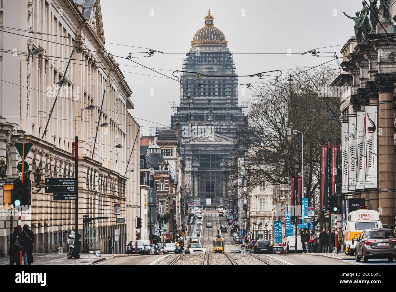 The busy thoroughfare of Rue de la Regence with a tramway on the street. At the end of the road the imposing Palais de Justice or Bruxelles Law Court Stock Photo