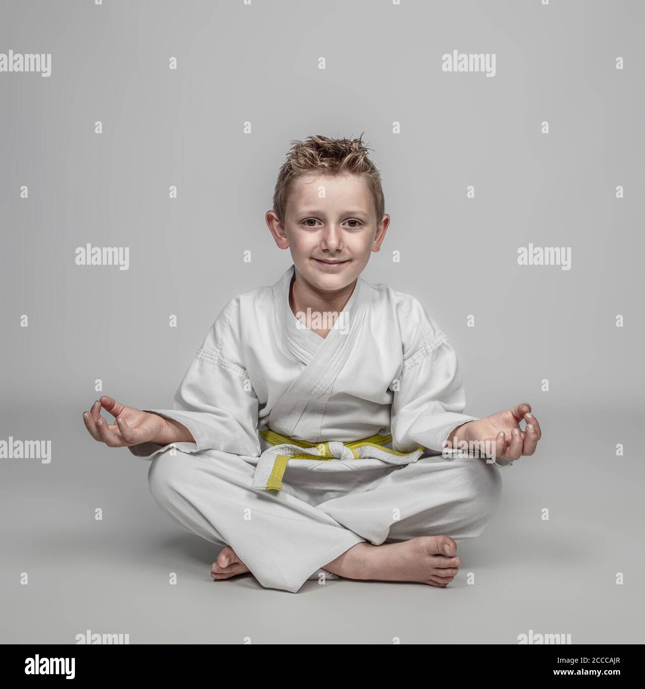 portrait of a child wearing martial arts kimono sitting in a meditative position Stock Photo Alamy