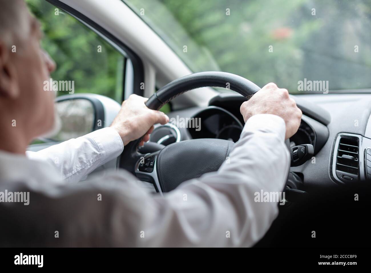 Man driving with his two hands on steering wheel Stock Photo Alamy