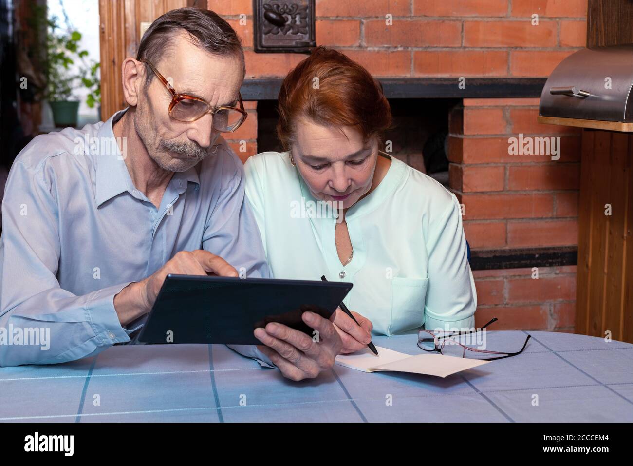 Senior couple and modern technologies with tablet Stock Photo