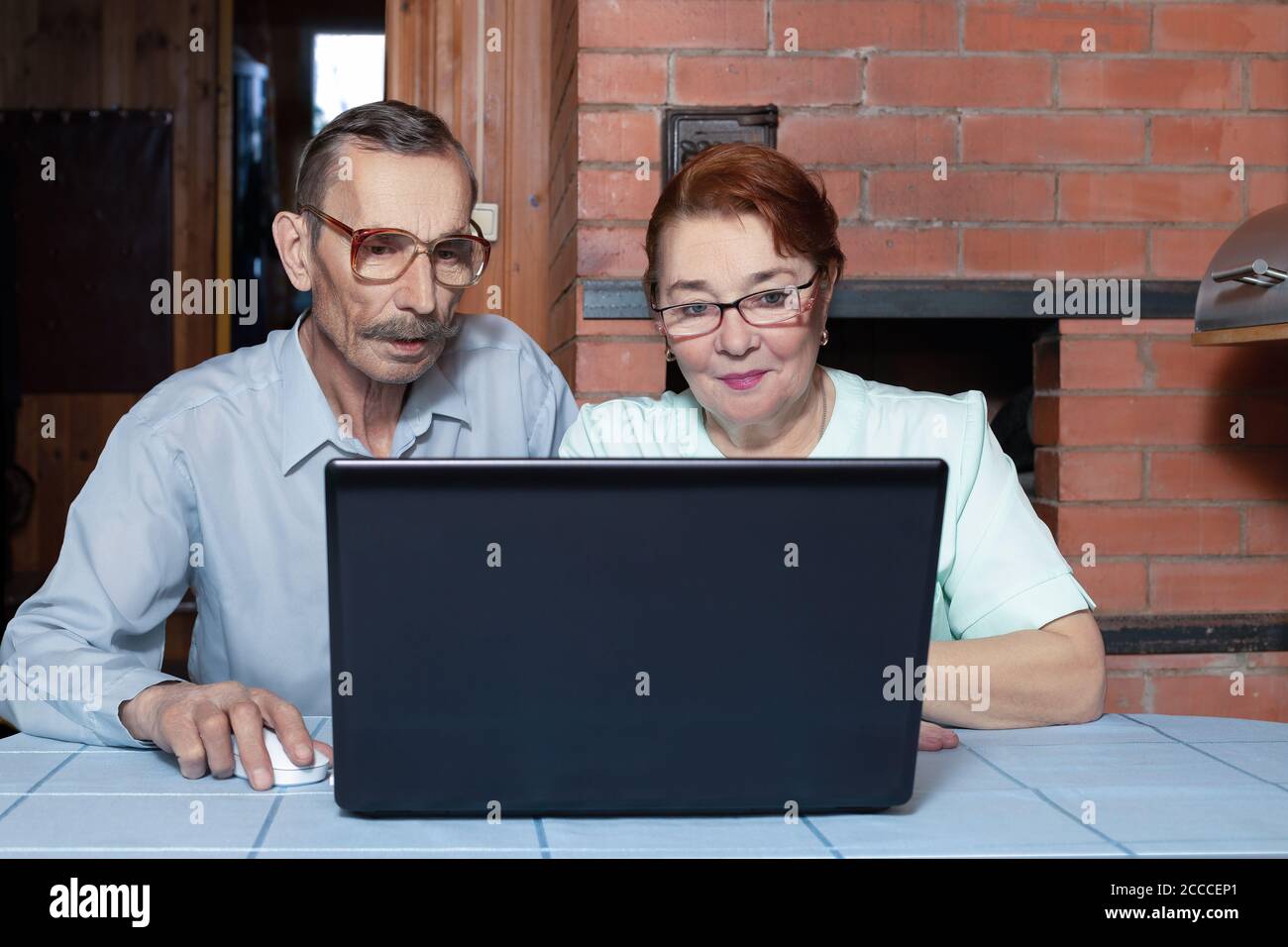Senior couple and modern technologies. Internet surfing with laptop Stock Photo