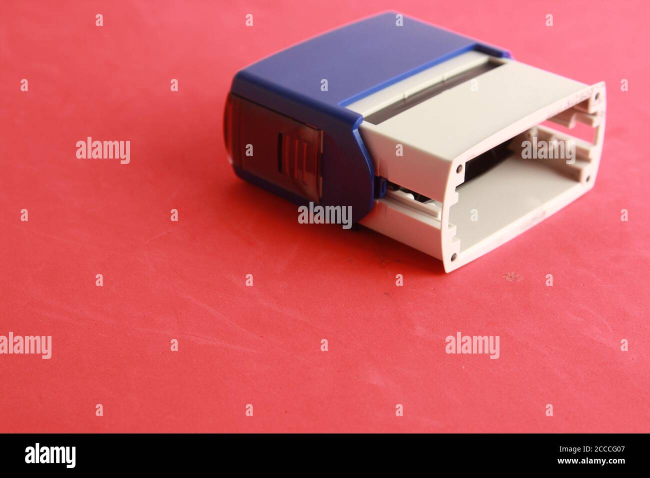 Automatic ink stamp on a red background Stock Photo Alamy
