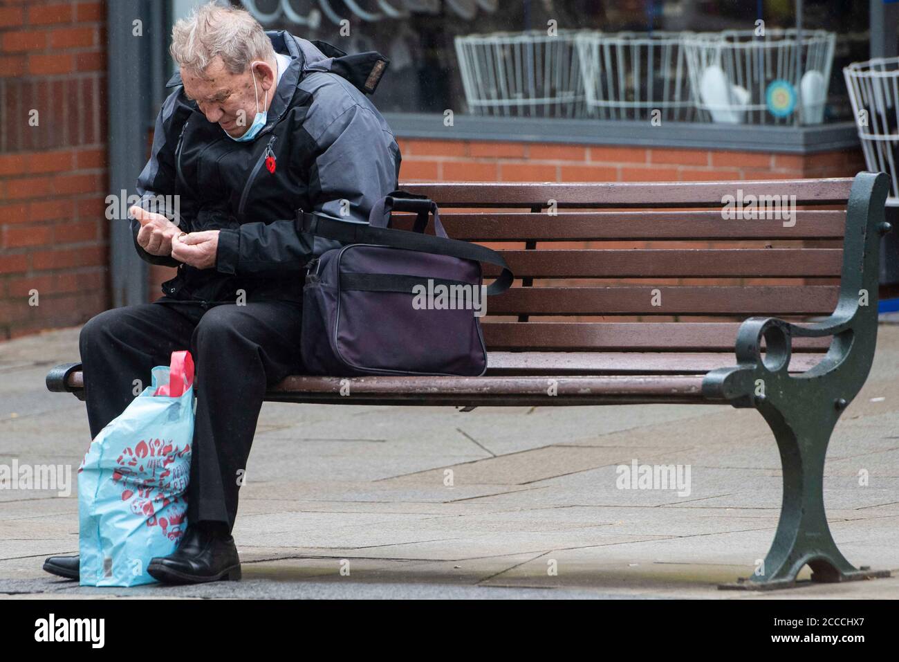 Oldham, UK.  21st Aug 2020  Pictured:  Wet, gloomy start to the day for members of the public in Oldham town centre, which teeters on the edge of lockdown. Credit: Kerry Elsworth/Alamy Live News Stock Photo