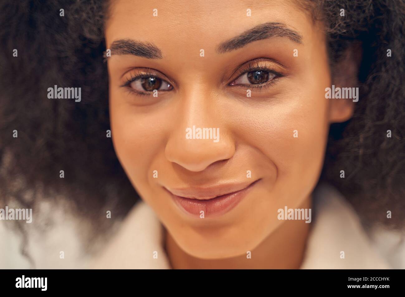 Lovely glance of positive Afro American lady Stock Photo - Alamy