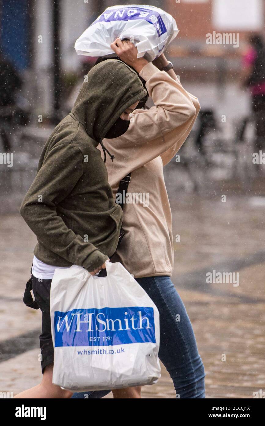 Oldham, UK.  21st Aug 2020  Pictured:  Wet, gloomy start to the day for members of the public in Oldham town centre, which teeters on the edge of lockdown. Credit: Kerry Elsworth/Alamy Live News Stock Photo