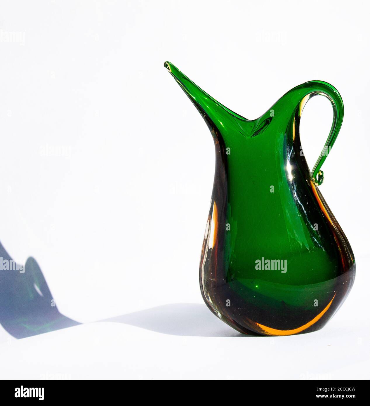 Murano handle vase in green uranium glass. Mouth blown. Stock Photo