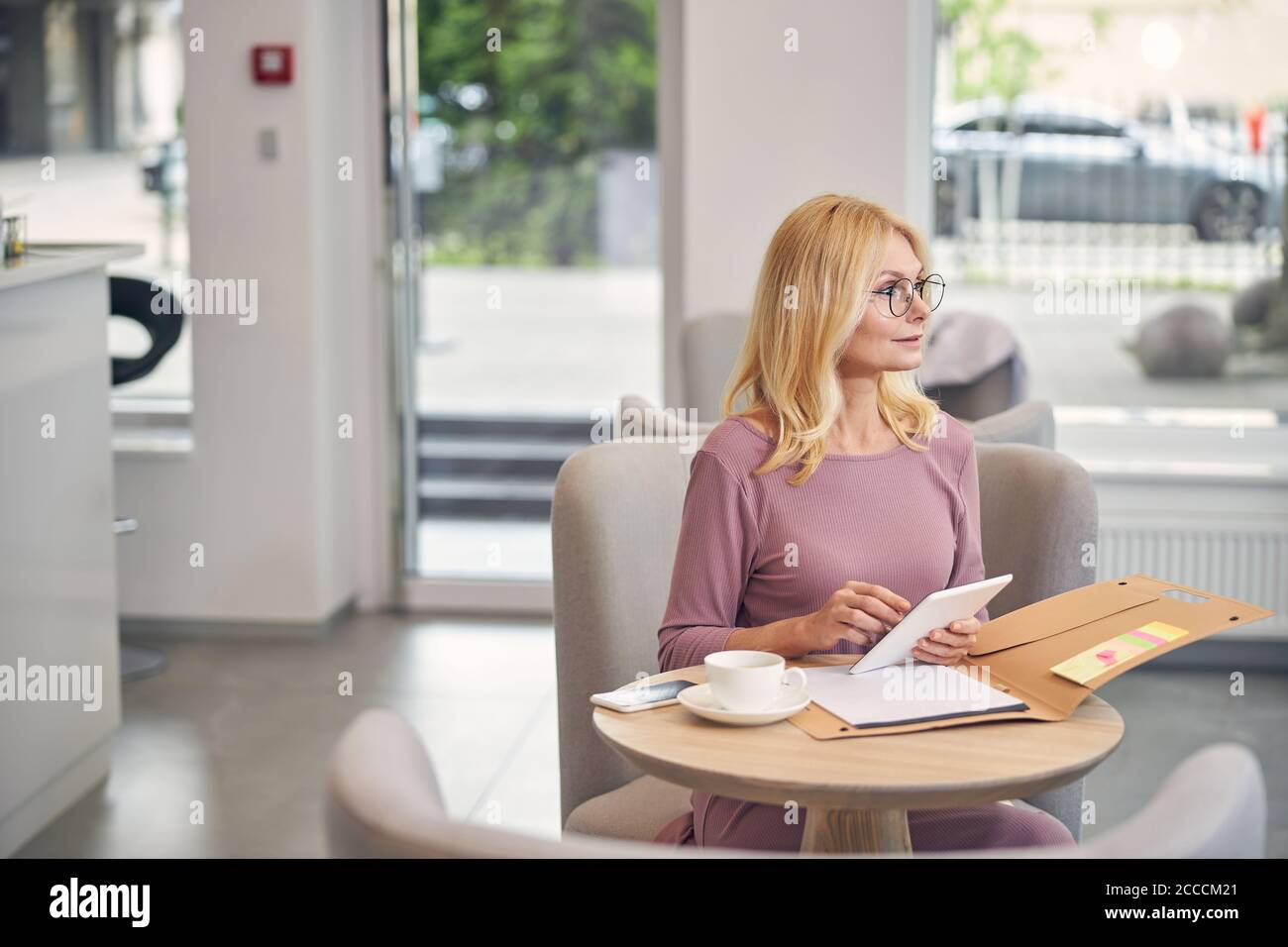 Pleased longhaired woman preparing for business meeting Stock Photo