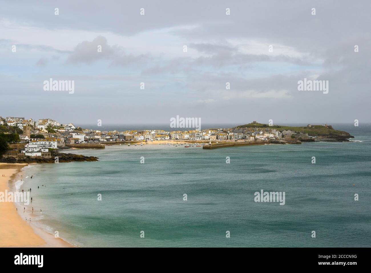 St Ives, Cornwall, UK.  21st August 2020.  UK Weather.  View of the harbour at the seaside resort of St Ives in Cornwall on a day of hazy sunshine.  Picture Credit: Graham Hunt/Alamy Live News Stock Photo