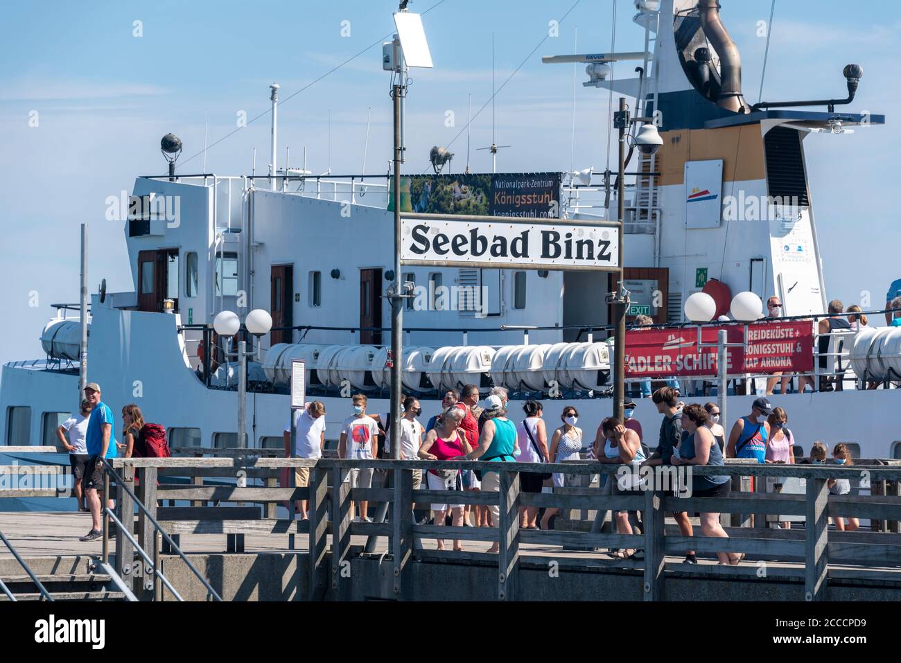 Binz, Germany. 17th Aug, 2020. Tourists stand on the pier in Binz, the largest Baltic seaside resort on the island of Rügen. The MS Cap Arkona has moored behind it. She brings holidaymakers several times a day to the chalk cliffs. Credit: Stephan Schulz/dpa-Zentralbild/ZB/dpa/Alamy Live News Stock Photo