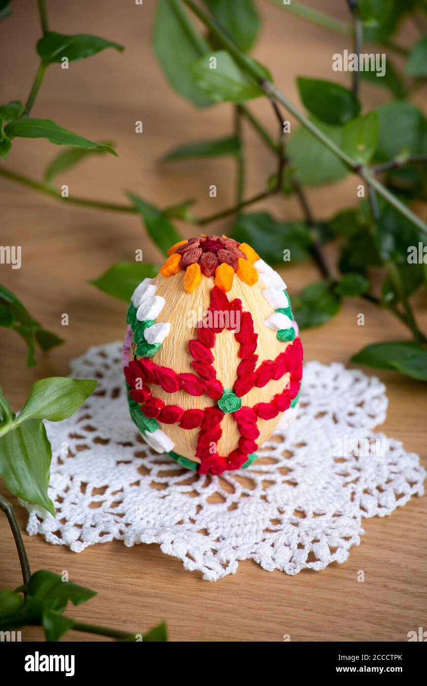 Easter egg made of paper, on a beautiful white napkin decoration of a