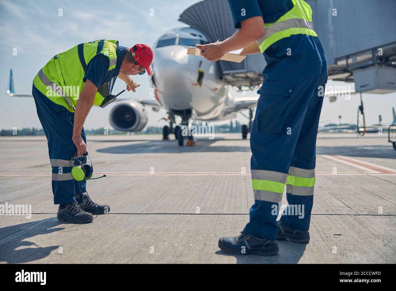 Aircraft maintenance technicians carrying out a post-flight inspection Stock Photo