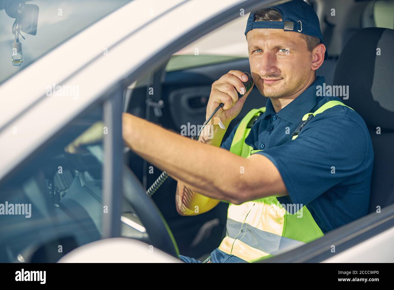 Vehicle operator keeping one hand on the steering wheel Stock Photo