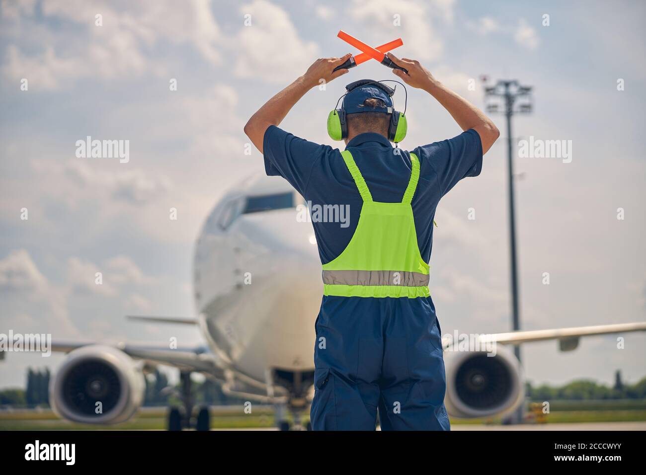 Man crossing the wands above the head Stock Photo