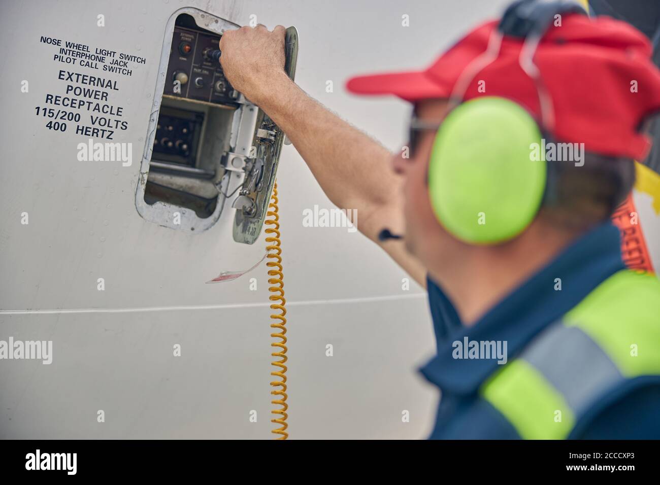 Experienced engineer checking the aircraft interphone system Stock