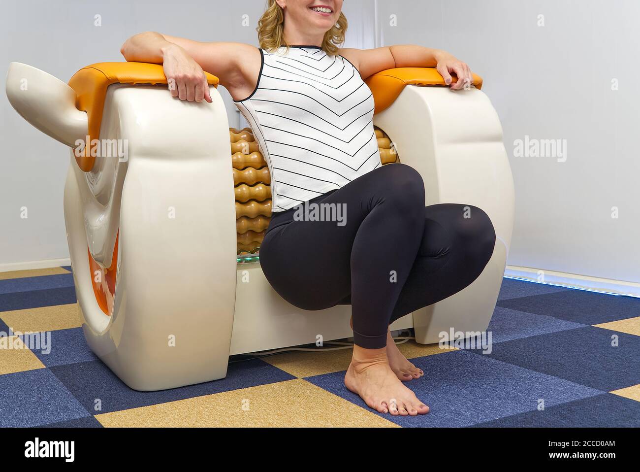 smiling woman making massage for back. Roll Massage machine is a way to  shape the figure. Skin Care, body care concept modern relax massage  equipment Stock Photo - Alamy