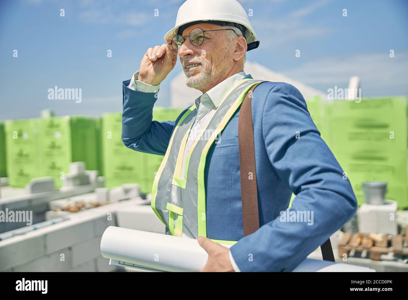 Civil engineer holding blueprints in his hand Stock Photo