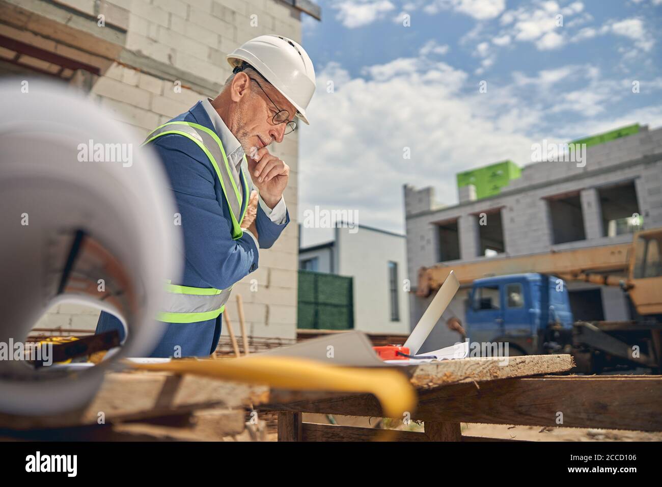 Man in eyeglasses leaning over his drawings Stock Photo