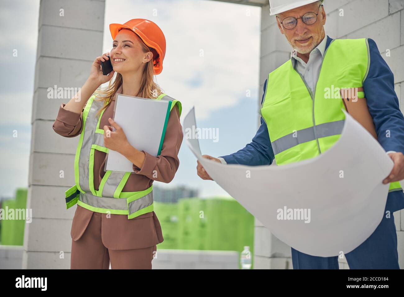 Smiling senior male engineer analyzing technical drawings Stock Photo
