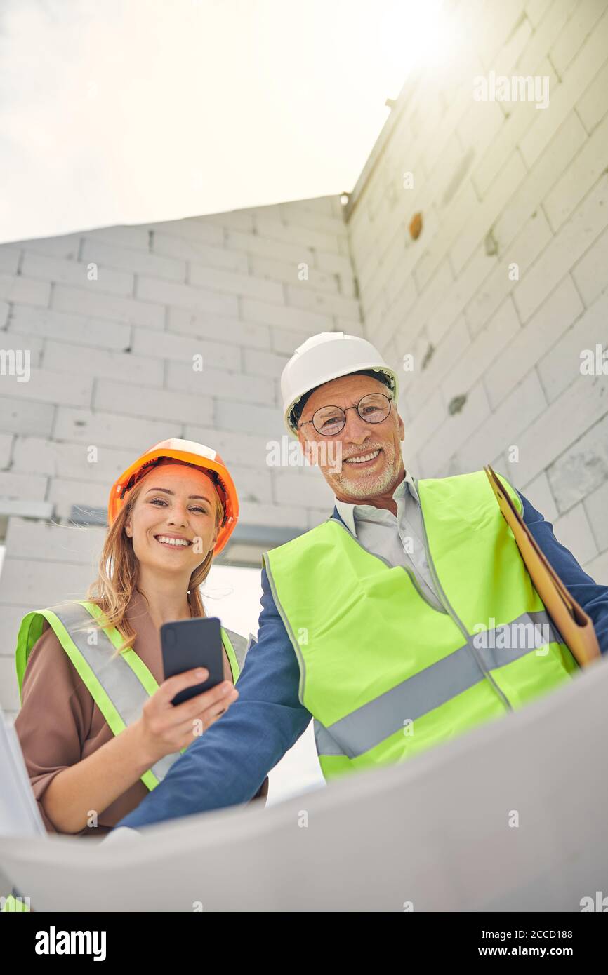 Senior constructor and a contractor posing for the camera Stock Photo
