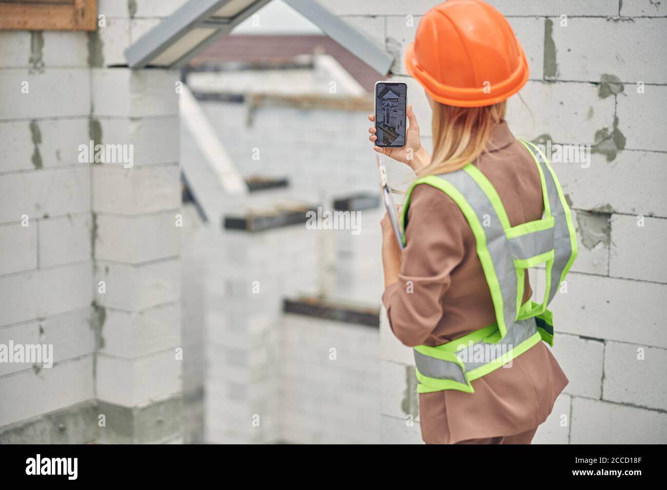 Civil engineer using her cellphone at work Stock Photo