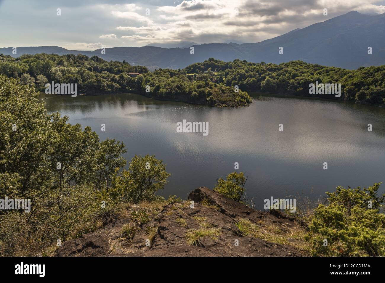 A beautiful shot of a lake surrounded by tree-covered hills Stock Photo ...