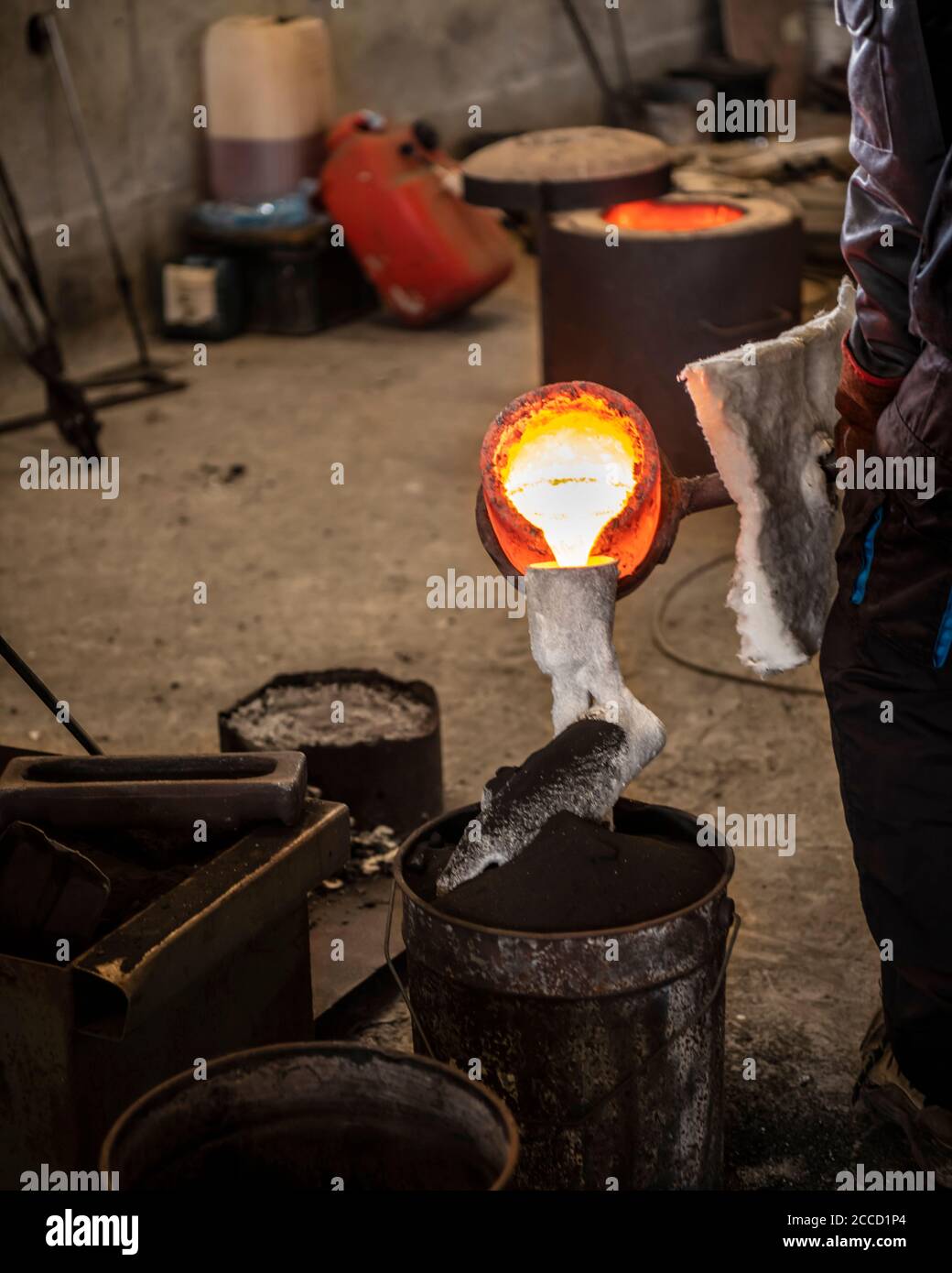 Casting the Bronze in small foundry. Sequence of images shows