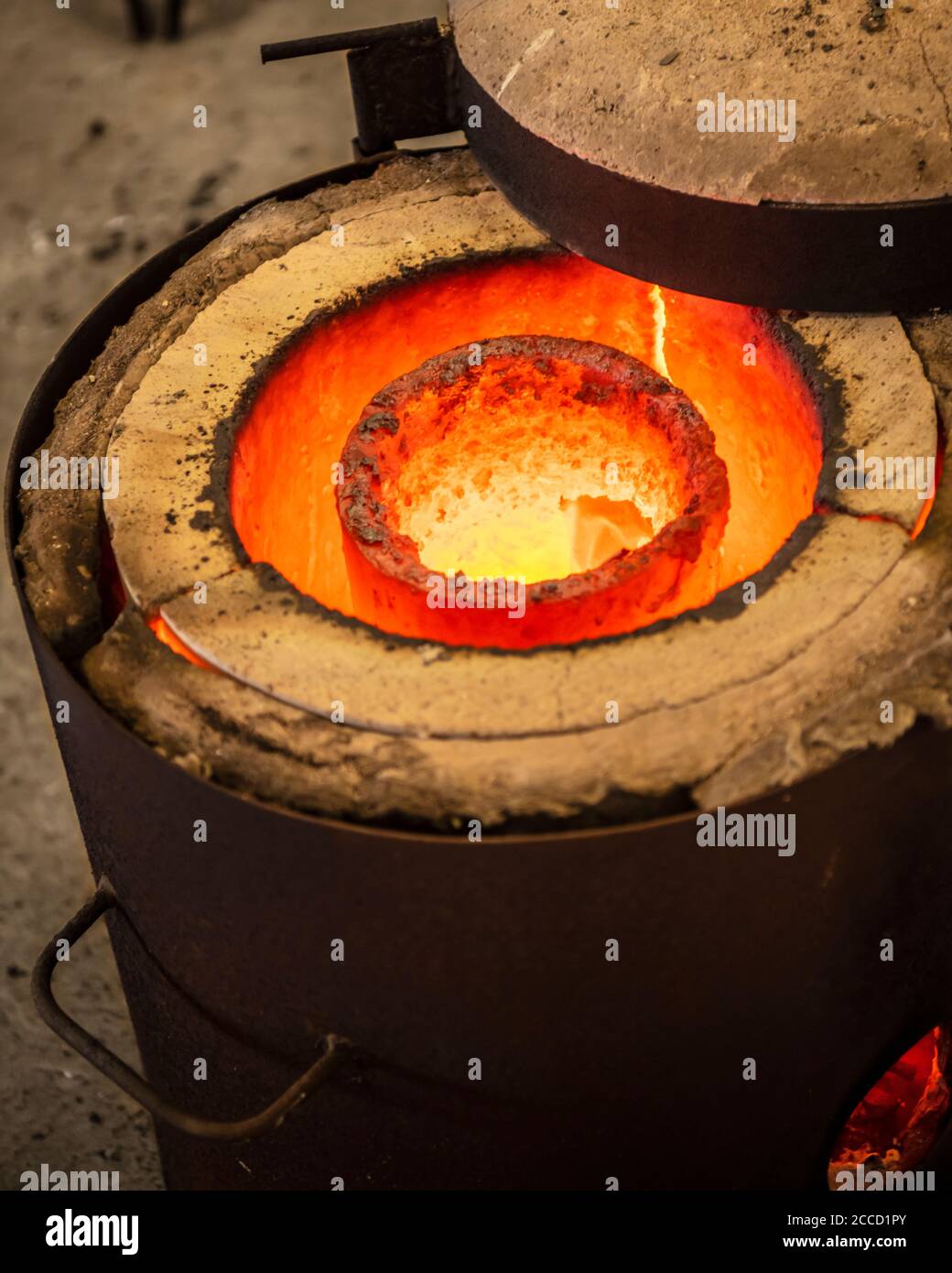 Casting the Bronze in small foundry. Sequence of images shows completely casting process from melting ingots to breaking ceramic shell of a sculpture. Stock Photo