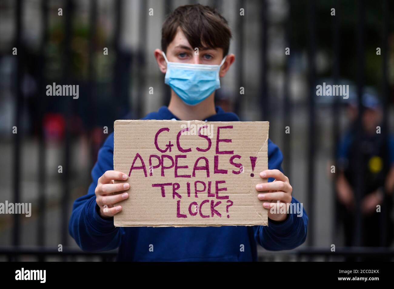 London, UK.  21 August 2020. GCSE and BTec student Tommy Walsh (aged 16) joins students protesting outside Downing Street calling for the resignation of Gavin Williamson, Secretary for Education, following this year’s exam results chaos.  After a successful campaign for A-Level and GCSE students to have grades based on teacher assessments rather than on a computer algorithm, BTec students will have to wait while exam board Pearson regrades their results.  (Parental permission obtained)  Credit: Stephen Chung / Alamy Live News Stock Photo