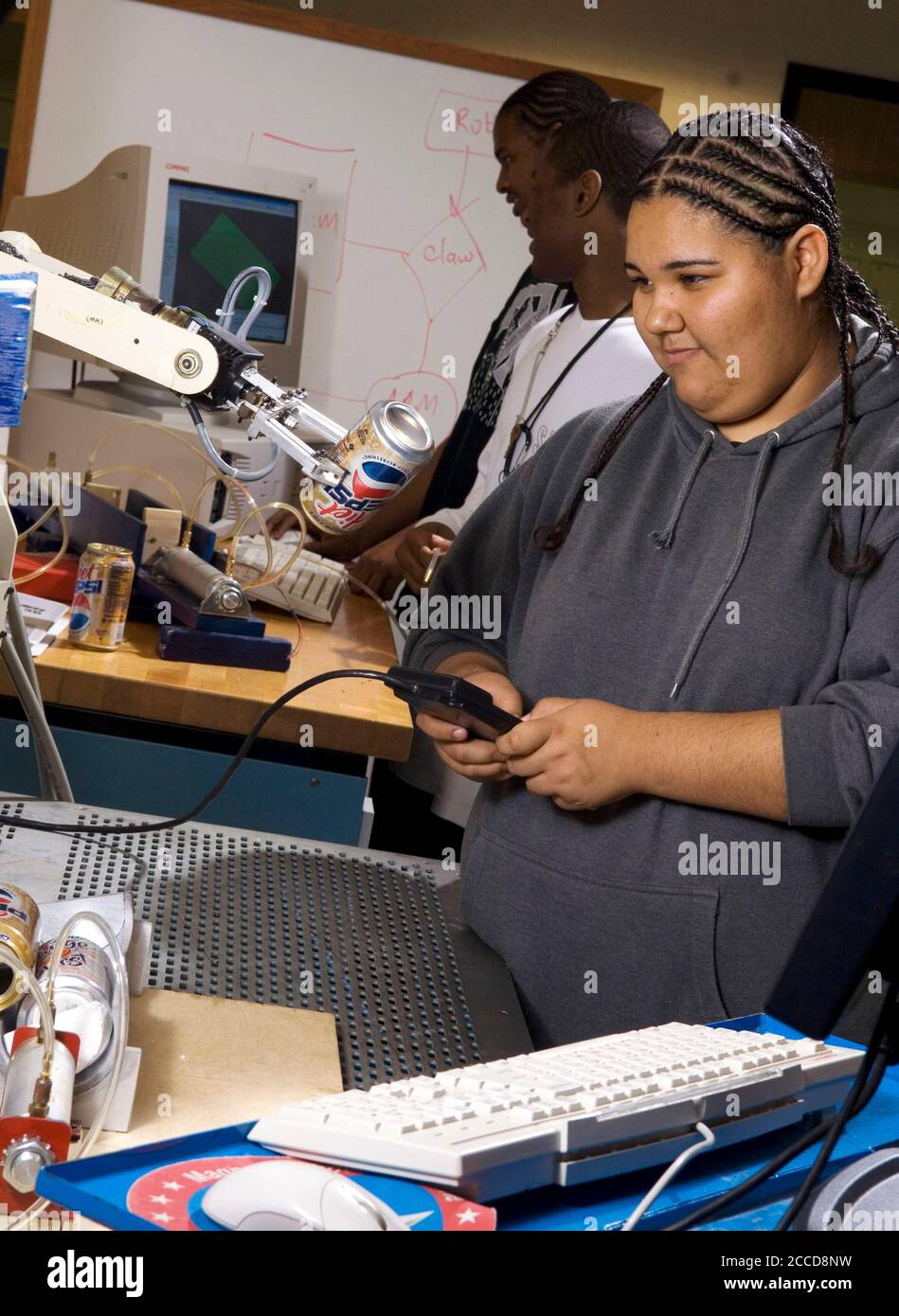 Houston, Texas USA, March 5, 2007: A Hispanic female high school student demonstrates robotics in a lab at the George Washington Carver Magnet High School for science and technology in the Aldine school district of Houston. ©Bob Daemmrich Stock Photo