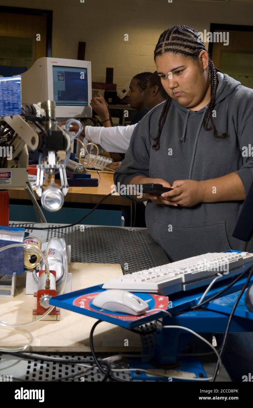 Houston, Texas USA, March 5, 2007: A Hispanic female high school student demonstrates robotics in a lab at the George Washington Carver Magnet High School for science and technology in the Aldine school district of Houston. ©Bob Daemmrich Stock Photo
