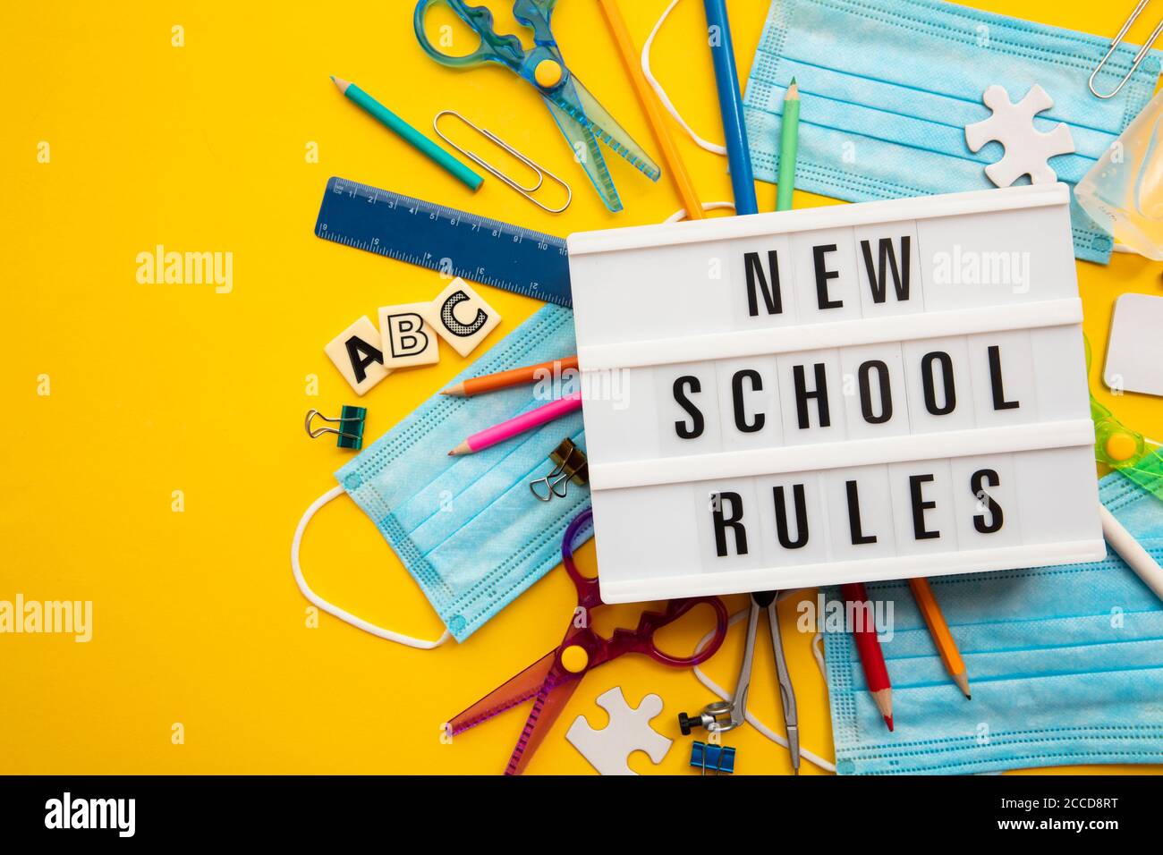 New school rules message with school equipment and covid masks Stock