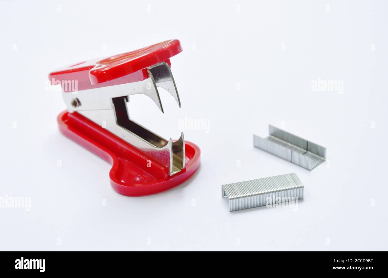 red staple remover and refill on white table Stock Photo