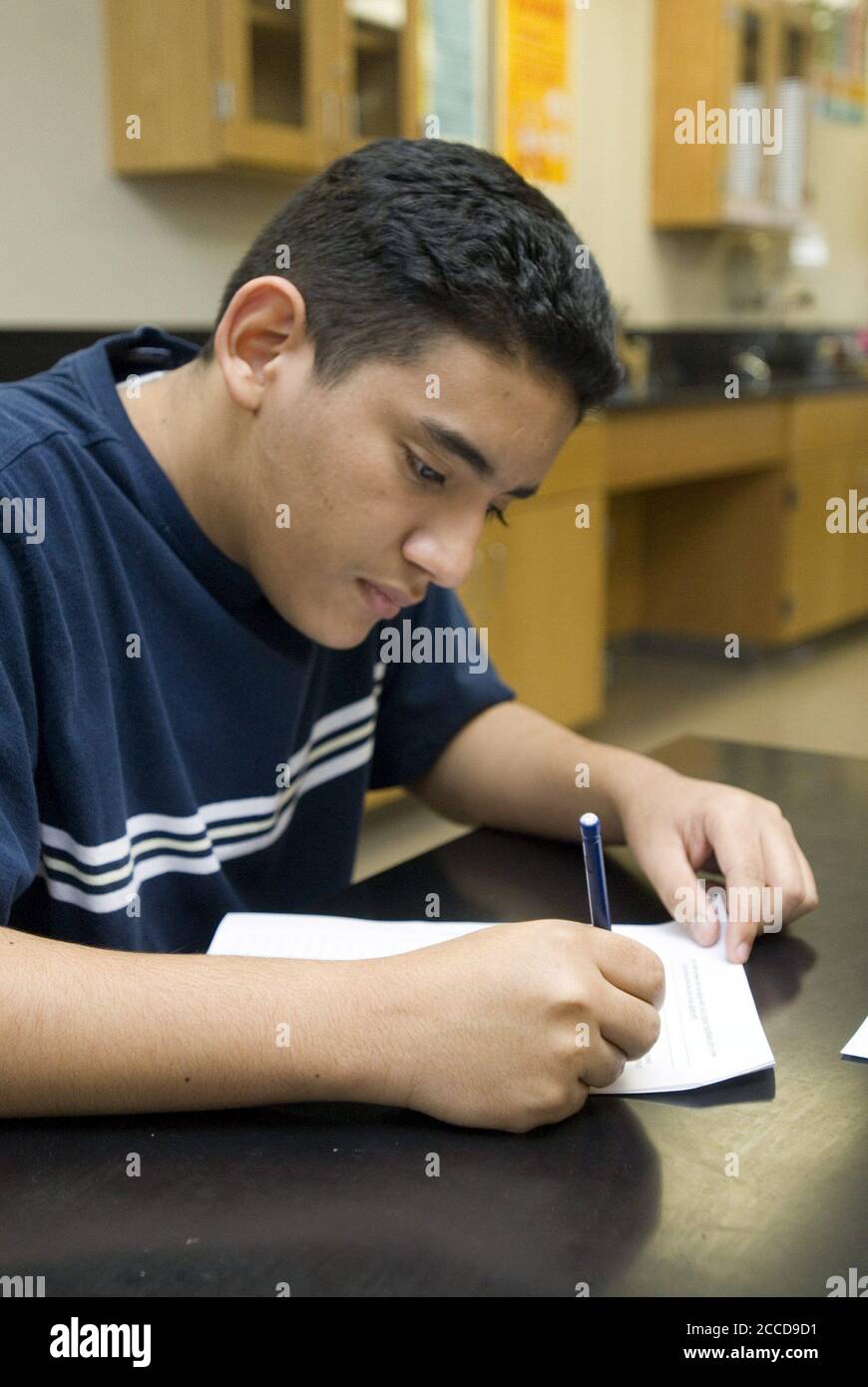 Texas: Hispanic 10th grade student writes during class. ©Marjorie Cotera/Daemmrich Photos Stock Photo