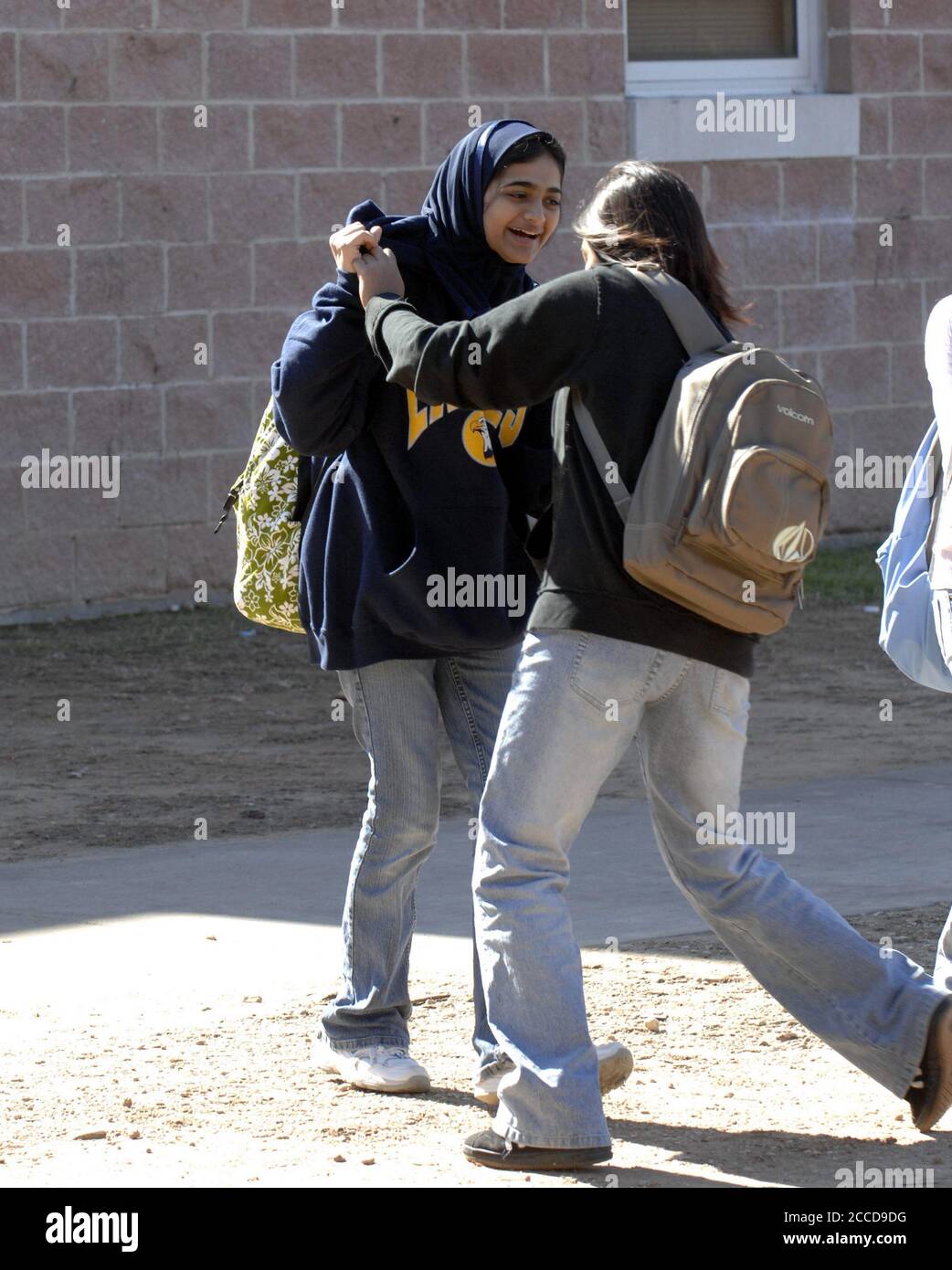 Austin, Texas USA, January 29, 2007: A ninth-grade Muslim female student plays with her friend at lunch hour at Akins High School, one of Texas' large high schools  redesigned  into smaller targeted 'academies' in order to improve learning and graduation rates. ©Bob Daemmrich Stock Photo