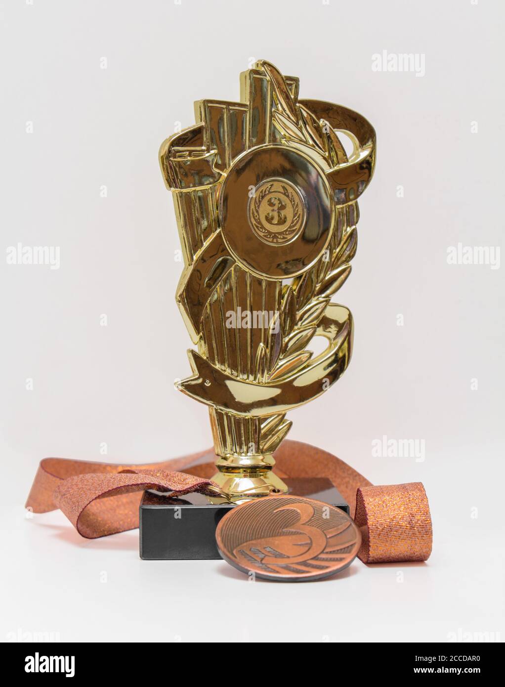 Third place, cup and medal, isolated Stock Photo
