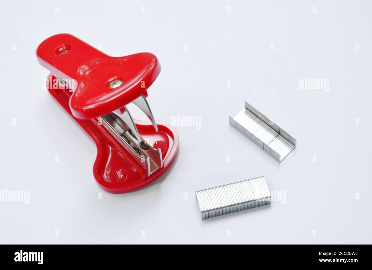 red staple remover and refill on white table Stock Photo