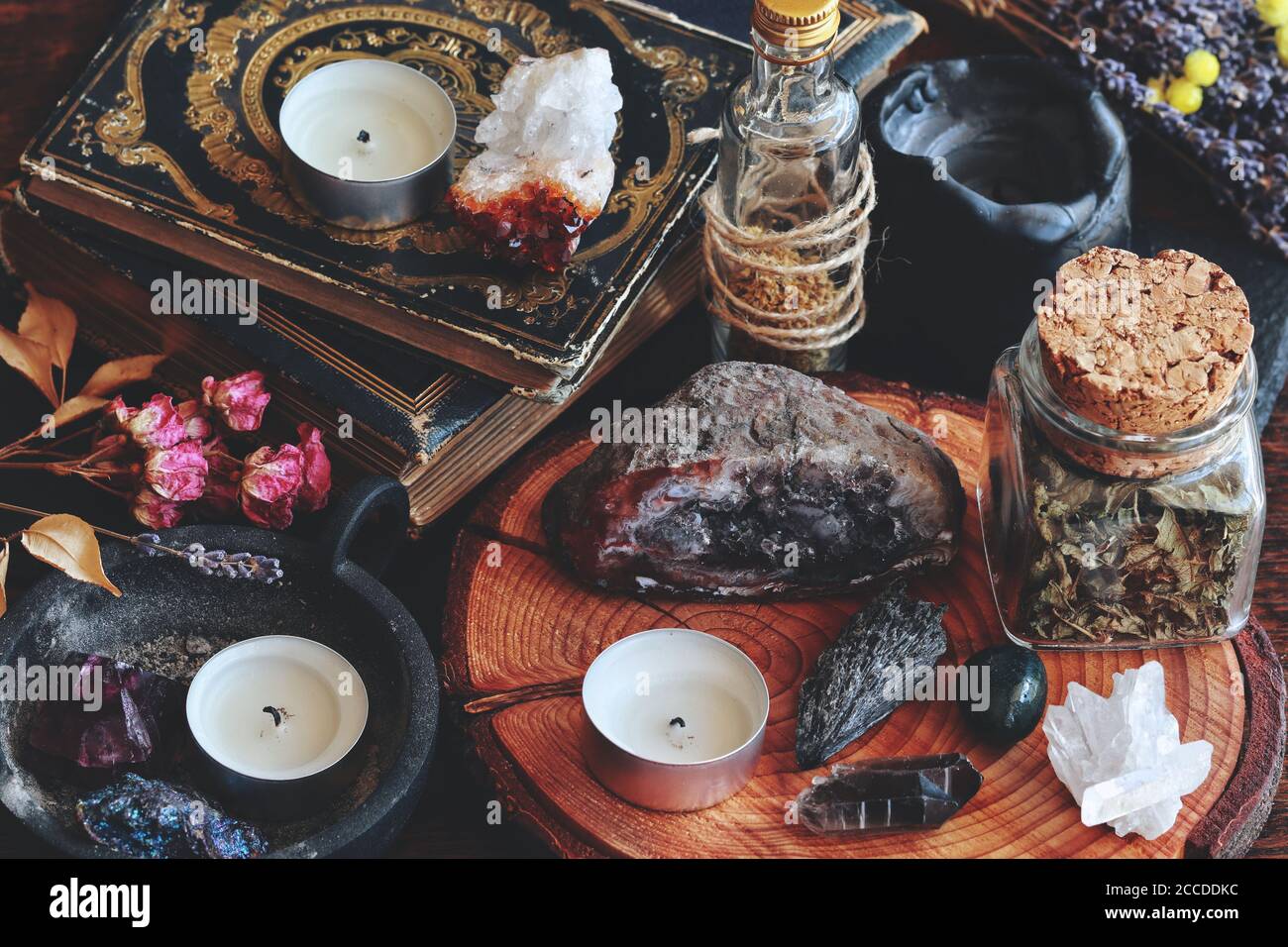 Different types of crystals on wiccan witch altar. Witchcraft themed dark photo with various crystals - kyanite, amethyst, peacock ore, smoky quartz Stock Photo