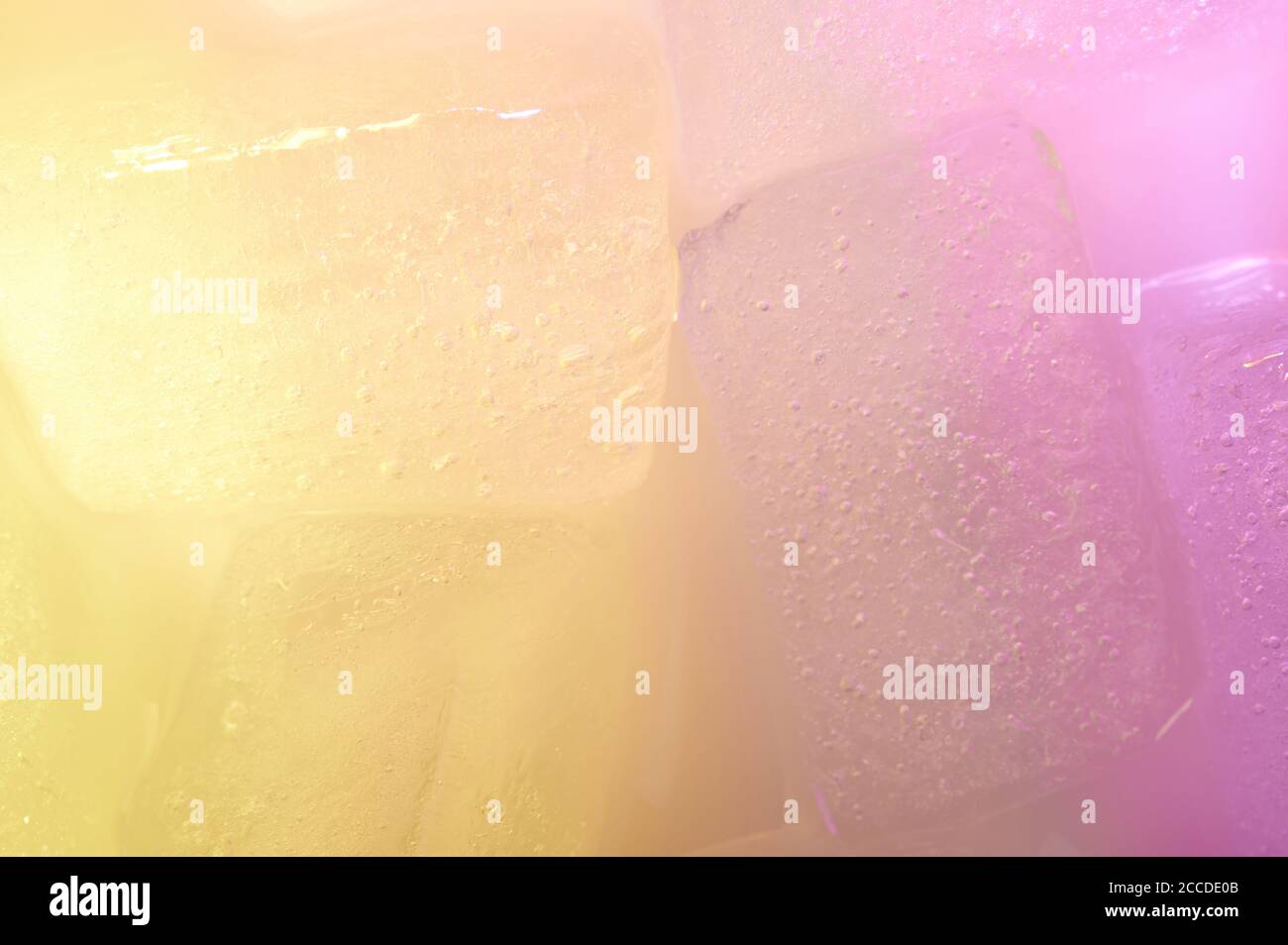 Macro of yellow and purple ice cubes close up background Stock Photo