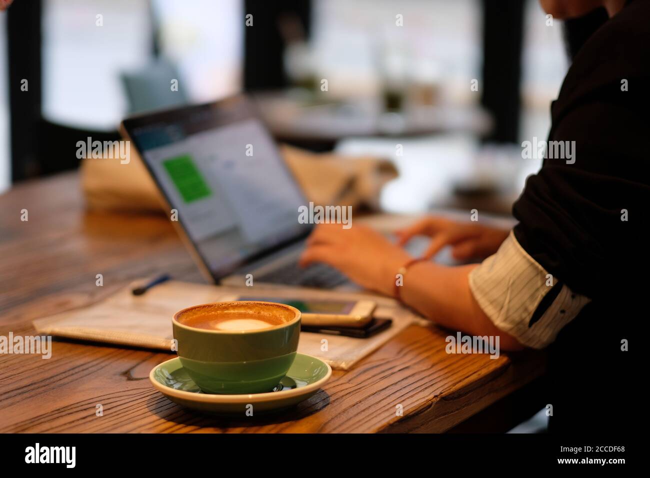 one woman using laptop computer, working in cafe. Blur background Stock Photo