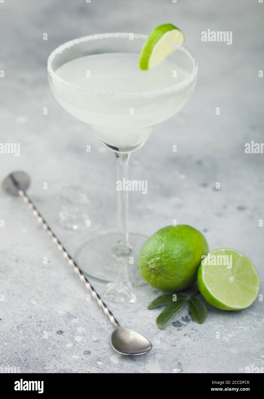 Classic crystal glass of Margarita cocktail with fresh lime and bar ...